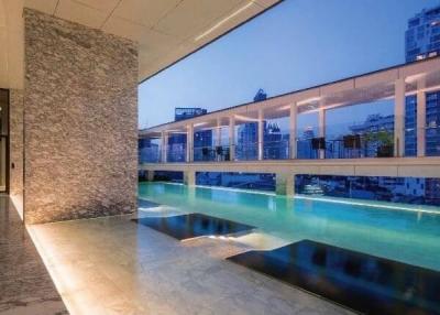 Luxurious balcony with a private pool overlooking the cityscape at dusk