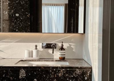 Modern bathroom with marble countertop and sunlight