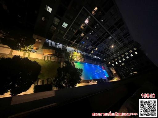 Building exterior at night with illuminated windows