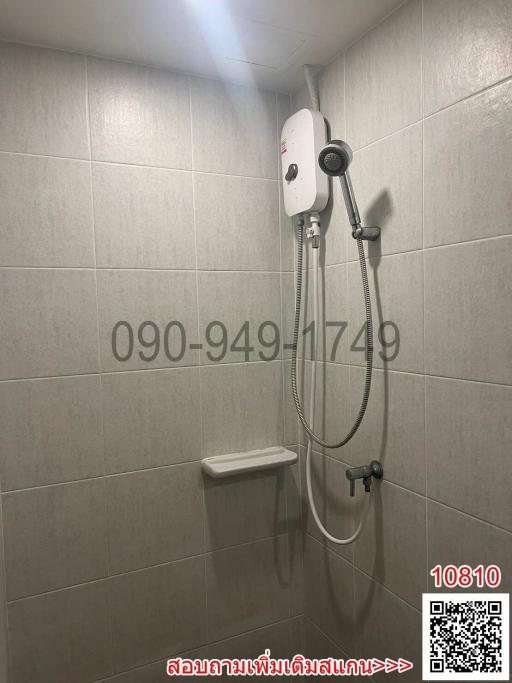 Compact bathroom with wall-mounted shower and water heater