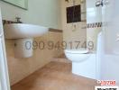 Modern bathroom with beige tiles and white fixtures