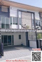 Modern two-storey residential building with balconies and stone accent walls