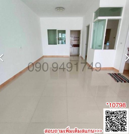 Spacious unfurnished living space with tiled flooring and large windows