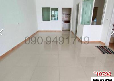 Spacious unfurnished living space with tiled flooring and large windows