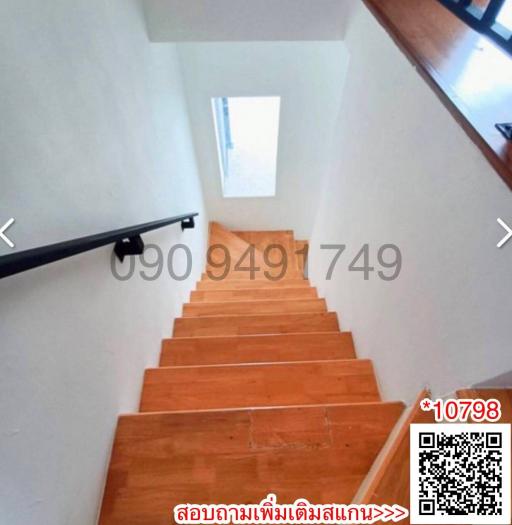 Wooden stairway with natural light coming from the window above