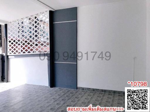 Modern building entrance with decorative partition wall and tiled flooring