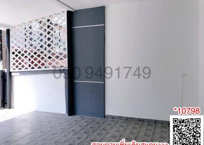 Modern building entrance with decorative partition wall and tiled flooring