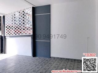 Spacious entryway of a building with patterned privacy screen and tiled flooring