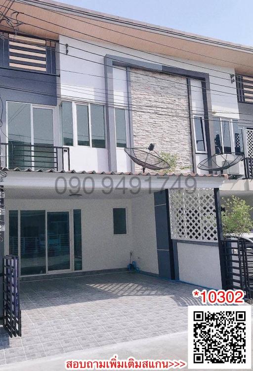 Modern two-story residential building with balcony and garage