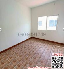 Spacious empty bedroom with two windows and tiled floor