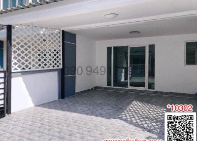 Spacious tiled patio with patterned shadow cast by a stylish overhead structure