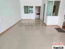Spacious unfurnished living room with tiled flooring and large windows