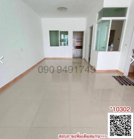 Spacious unfurnished living room with tiled flooring and large windows