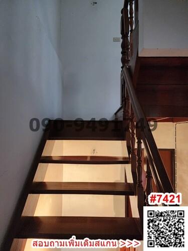 Wooden staircase with balusters leading to the upper level of a home