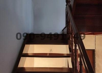 Wooden staircase with balusters leading to the upper level of a home