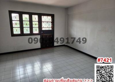 Simple bedroom with tiled flooring and natural light from windows