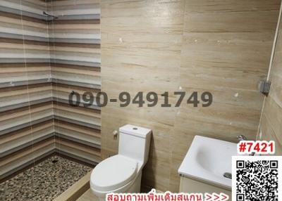 Compact bathroom with modern fixtures and tiled walls