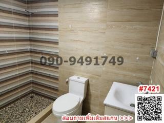 Compact bathroom with modern fixtures and tiled walls