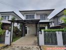 Modern two-story house with carport and gated entry