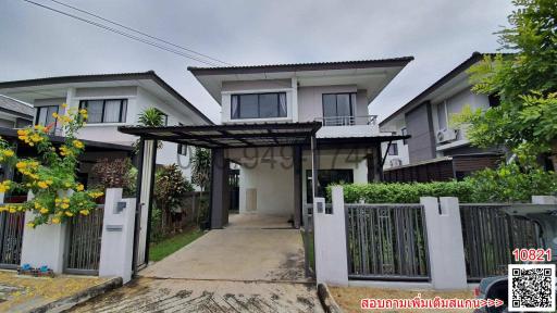 Modern two-story house with carport and gated entry