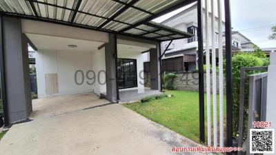 Front view of a modern house with carport and lawn