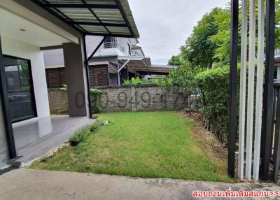 Front yard of a modern residential house with a green lawn