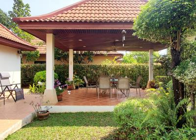 Patio area with outdoor furniture and landscaped garden