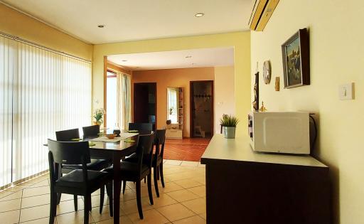 Spacious dining room with open doorway leading to additional rooms