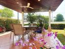 Spacious covered patio with outdoor furniture and garden view