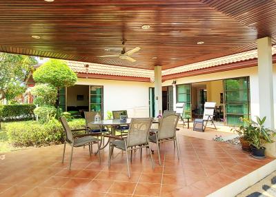 Spacious patio area with outdoor furniture and garden view