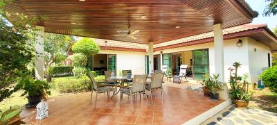 Spacious patio area with outdoor furniture and garden view