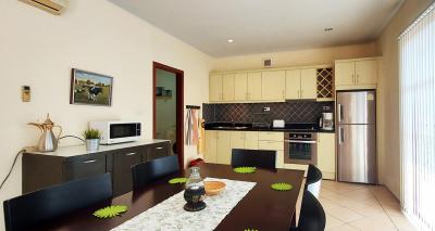 Modern kitchen with dining area, stainless steel appliances, and ample cabinetry
