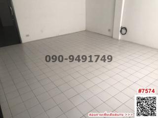 Empty room with tiled flooring and white walls in a building