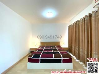 Spacious bedroom with a large bed and ample lighting