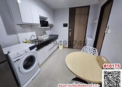 Compact modern kitchen with washing machine and dining area