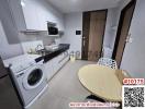 Compact modern kitchen with washing machine and dining area