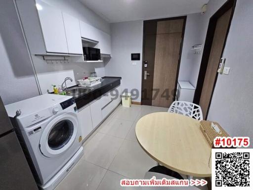 Compact modern kitchen with washing machine and dining area