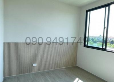 Bright empty bedroom with large window
