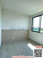 Bright empty bedroom with large window