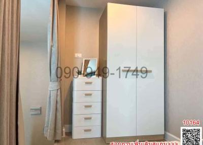 bedroom with a white wardrobe and a white drawer chest