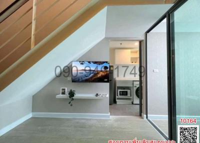 Modern living area with stairway and adjacent laundry room