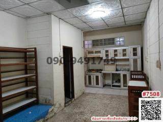 Compact kitchen space with built-in shelving and cabinetry