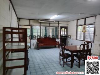 Spacious unfurnished living room with blue tiled flooring and multiple windows