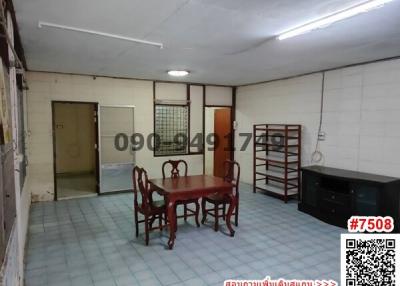 Spacious unfurnished interior of a building with a wooden dining set