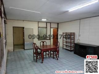 Spacious unfurnished interior of a building with a wooden dining set