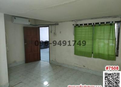 Spacious room with ceramic tiles, air conditioning unit, and green curtains