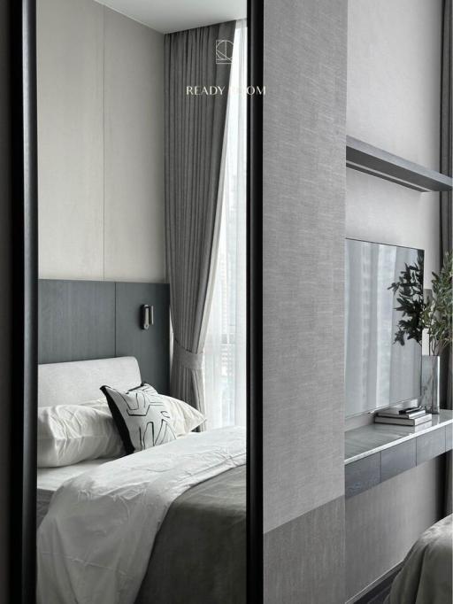 Modern bedroom with large window and elegant decor