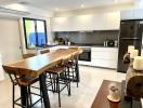 Modern kitchen with wooden breakfast bar and stainless steel appliances