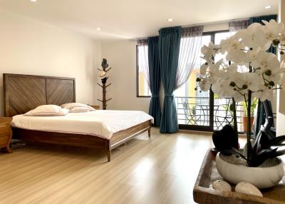 Spacious bedroom with king-sized bed and balcony access