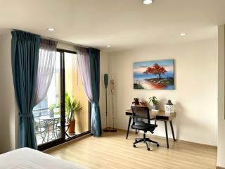 Bright and airy bedroom with balcony access and a picturesque view